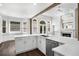 Contemporary kitchen featuring a spacious island with stainless steel appliances and bright lighting at 7025 Bavarian Wood Pl, Buford, GA 30518