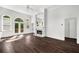 Bright living room with hardwood floors, fireplace, and french doors to the outside at 7025 Bavarian Wood Pl, Buford, GA 30518