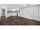 A cozy living space with dark hardwood floors and new stainless steel appliances at 7025 Bavarian Wood Pl, Buford, GA 30518