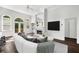Bright living room boasts a fireplace, a large TV, and beautiful windows for natural lighting at 7025 Bavarian Wood Pl, Buford, GA 30518