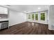 Bright living space with hardwood floors, modern appliances, and French doors to the outside at 7025 Bavarian Wood Pl, Buford, GA 30518