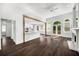 Open-concept living room with fireplace, hardwood floors, and seamless kitchen access at 7025 Bavarian Wood Pl, Buford, GA 30518