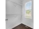 Walk-in closet featuring shelving and a window for natural light at 7025 Bavarian Wood Pl, Buford, GA 30518