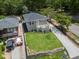 A house and a well-kept lawn are showcased from an aerial perspective on a sunny day at 1603 Ezra Church Nw Dr, Atlanta, GA 30314