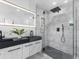 Bright bathroom featuring double vanity, glass enclosed shower, and marble tile at 1603 Ezra Church Nw Dr, Atlanta, GA 30314
