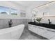 Bright bathroom with freestanding tub, double vanity, and marble tile at 1603 Ezra Church Nw Dr, Atlanta, GA 30314