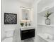 Modern bathroom features black and gold vanity and an illuminated mirror at 1603 Ezra Church Nw Dr, Atlanta, GA 30314