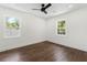 Bright bedroom with hardwood floors, two windows, and a ceiling fan at 1603 Ezra Church Nw Dr, Atlanta, GA 30314