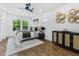 Comfortable bedroom featuring a ceiling fan, hardwood floors, and natural light at 1603 Ezra Church Nw Dr, Atlanta, GA 30314