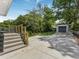 Well-maintained home exterior with a concrete driveway leading to a gray garage and a small deck at 1603 Ezra Church Nw Dr, Atlanta, GA 30314