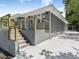 Stylish exterior featuring a gray brick facade, modern railings, and a paved walkway to a detached garage at 1603 Ezra Church Nw Dr, Atlanta, GA 30314
