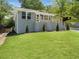 Charming gray brick home with a well-manicured front yard and a modern-railed front porch at 1603 Ezra Church Nw Dr, Atlanta, GA 30314