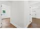 Bright hallway featuring hardwood flooring and white walls at 1603 Ezra Church Nw Dr, Atlanta, GA 30314