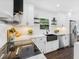A modern kitchen featuring white cabinets, stainless steel appliances, and a black farmhouse sink at 1603 Ezra Church Nw Dr, Atlanta, GA 30314
