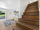 Staircase with wood steps leads to a sitting area with white chairs at 1603 Ezra Church Nw Dr, Atlanta, GA 30314