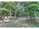 Large backyard featuring mature trees, offering a natural retreat for relaxation and outdoor activities at 1882 Flowering Dr, Grayson, GA 30017
