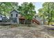 Exterior of home with a backyard featuring a deck, lush trees, and ample room for play and relaxation at 1882 Flowering Dr, Grayson, GA 30017
