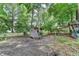 Wooded backyard with playhouse and swing set offering a private area to create an outdoor haven at 1882 Flowering Dr, Grayson, GA 30017