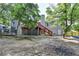 Home exterior with a backyard featuring a deck, lush trees, and ample space for fun and leisure at 1882 Flowering Dr, Grayson, GA 30017