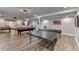 Spacious finished basement with a pool table, ping pong table, and light hardwood floors at 1882 Flowering Dr, Grayson, GA 30017