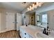 Modern bathroom featuring dual sinks, a large mirror, separate shower, and soaking tub at 1882 Flowering Dr, Grayson, GA 30017