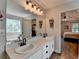 Bright bathroom featuring double sinks, large mirror, soaking tub and an open door to the bedroom at 1882 Flowering Dr, Grayson, GA 30017