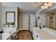 Well-appointed bathroom with dual sinks, soaking tub, separate shower, and stylish fixtures at 1882 Flowering Dr, Grayson, GA 30017