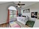 Cozy bedroom with an arched window, wood floors, and gymnastic bar at 1882 Flowering Dr, Grayson, GA 30017