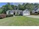 Beautifully landscaped home with two-car garage, manicured lawn, and stone facade at 1882 Flowering Dr, Grayson, GA 30017