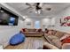 Finished living room with couches, hardwood floors, a ceiling fan, and a TV at 1882 Flowering Dr, Grayson, GA 30017