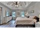 Inviting main bedroom with tray ceiling, fan, and dual windows, offering comfort and style at 1882 Flowering Dr, Grayson, GA 30017