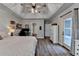 Bright main bedroom boasting tray ceiling, wood floors, and access to a private outdoor space at 1882 Flowering Dr, Grayson, GA 30017