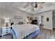 Comfortable main bedroom with tray ceiling, fan, and ample space, perfect for rest and relaxation at 1882 Flowering Dr, Grayson, GA 30017