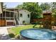 Lush backyard featuring a stock tank pool, play structure, and a screened-in porch at 1256 Euclid Ne Ave, Atlanta, GA 30307