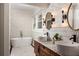 Modern bathroom with free-standing tub, dual sinks, and chic floral wallpaper design at 1256 Euclid Ne Ave, Atlanta, GA 30307