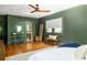 Bright, spacious bedroom featuring hardwood floors, a ceiling fan, and a full view of the doorway to the bathroom at 1256 Euclid Ne Ave, Atlanta, GA 30307