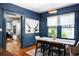 Dining room with blue accent walls and modern pendant light fixture at 1256 Euclid Ne Ave, Atlanta, GA 30307