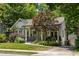 Charming house with a stone chimney, covered porch, and detached garage at 1256 Euclid Ne Ave, Atlanta, GA 30307