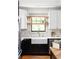 Charming kitchen featuring black cabinets, white countertop, farmhouse sink, and gold faucet at 1256 Euclid Ne Ave, Atlanta, GA 30307