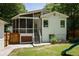 Charming screened-in porch and backyard with a play structure and lush landscaping at 1256 Euclid Ne Ave, Atlanta, GA 30307