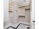 A walk-in closet with custom shelving and marble floors at 1256 Euclid Ne Ave, Atlanta, GA 30307