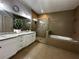 Modern bathroom featuring double sinks, granite counters, walk-in shower, and soaking tub at 2657 Gray Mill Way, Loganville, GA 30052