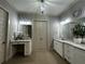 Bathroom featuring double vanities, a make-up vanity, tiled floors, and neutral paint at 2657 Gray Mill Way, Loganville, GA 30052