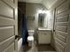 Bathroom with tiled floors, bathtub, shower, vanity, and toilet at 2657 Gray Mill Way, Loganville, GA 30052