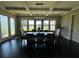 Dining area with views of the lake and an elegant light fixture over the dining table at 2657 Gray Mill Way, Loganville, GA 30052