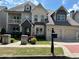 Charming home featuring a two-car garage, well-manicured landscaping, and a mix of stone and siding exterior at 2657 Gray Mill Way, Loganville, GA 30052