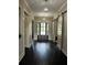 Elegant foyer featuring dark hardwood floors, gray walls, and stylish sliding barn doors at 2657 Gray Mill Way, Loganville, GA 30052