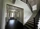 Bright foyer with hardwood floors and staircase with contrasting white risers at 2657 Gray Mill Way, Loganville, GA 30052
