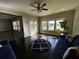 Open living room with dark wood floors, ceiling fan, and lots of natural light from the nearby balcony and lake views at 2657 Gray Mill Way, Loganville, GA 30052