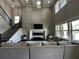 Open living room featuring a fireplace, staircase, high ceilings and lots of natural light at 2657 Gray Mill Way, Loganville, GA 30052